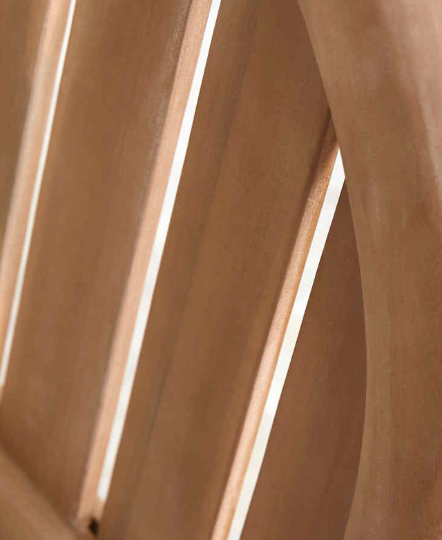 A bottom-up view of the bench spotlights the slatting and the even gaps between wood panels. A bottom-up view of the bench spotlights the slatting and the even gaps between wood panels.