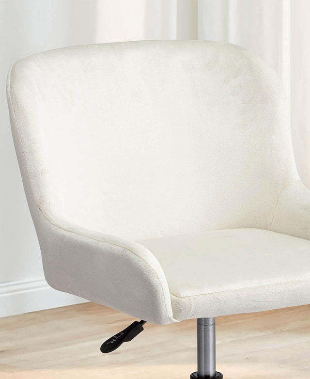 The cream office chair is upholstered in a silky velvet fabric.