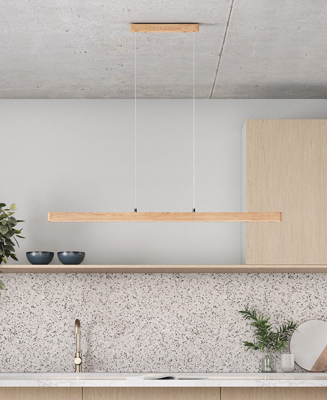 The linear, timber pendant light is hung from a concrete ceiling in a contemporary, bright kitchen. The linear, timber pendant light is hung from a concrete ceiling in a contemporary, bright kitchen.