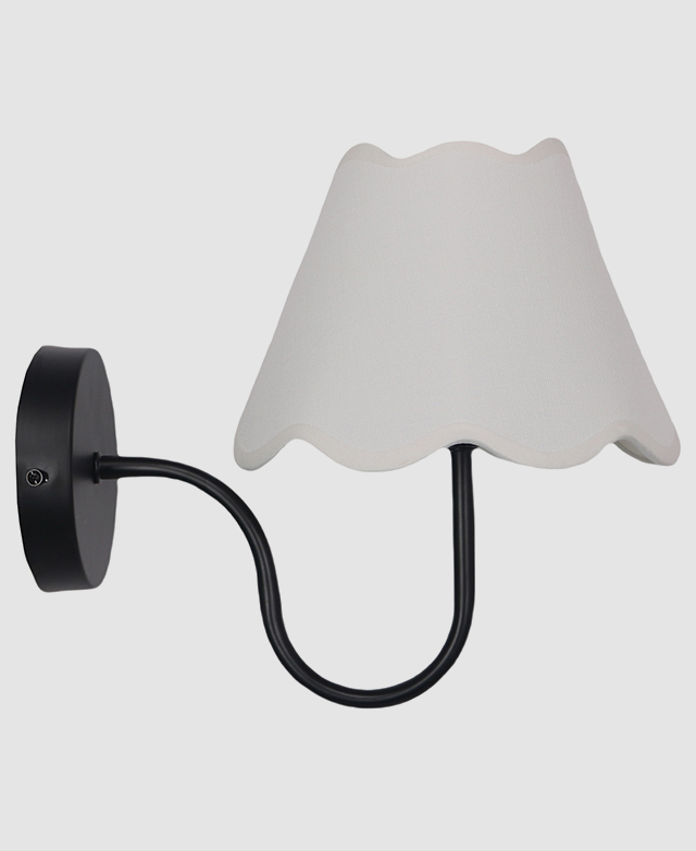 The black wall light is shown in full to highlight its slender, curved metal arm and well-proportioned fabric shade.