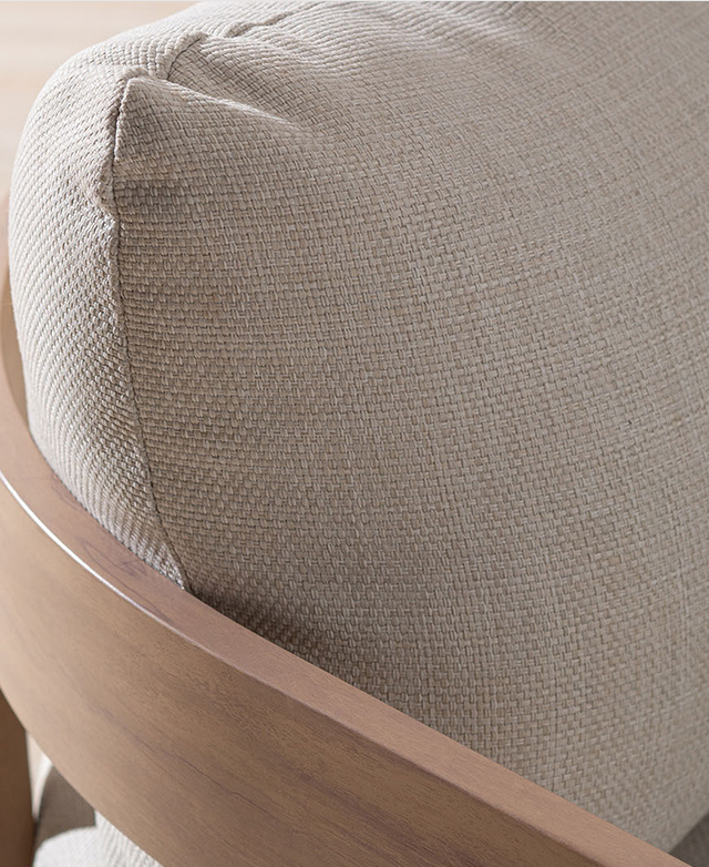 Off-white Olefin fabric is the cushion cover for the armchair, featured close up to reveal its weave pattern.