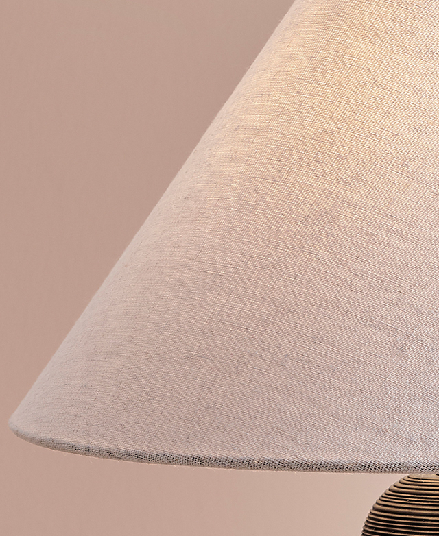 A close up of the neutral fabric empire shade highlights its gently textured surface.