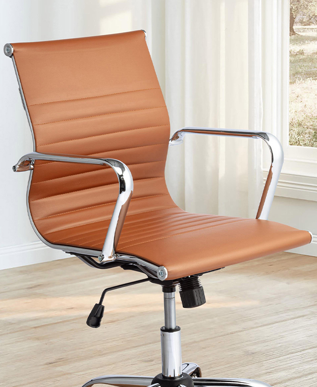 Shown in a bright room on a timber floor, the tan office chair features horizontal channel tufting and a sleek metal frame.