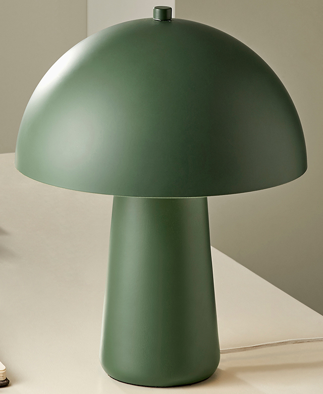 The full mushroom-shaped green lamp is on a white surface. It has a matte finish.