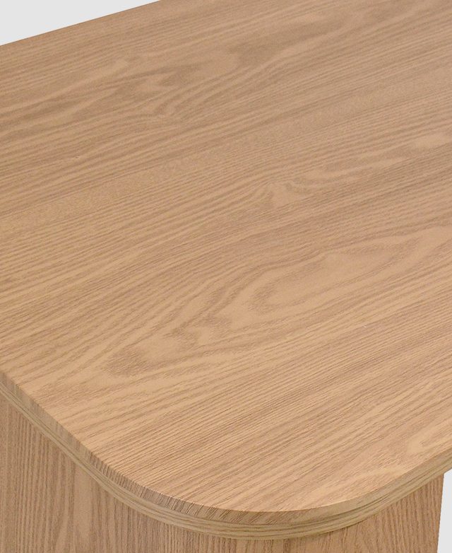 Top-down view shows a curved corner and the oak-look laminate finish. Top-down view shows a curved corner and the oak-look laminate finish.