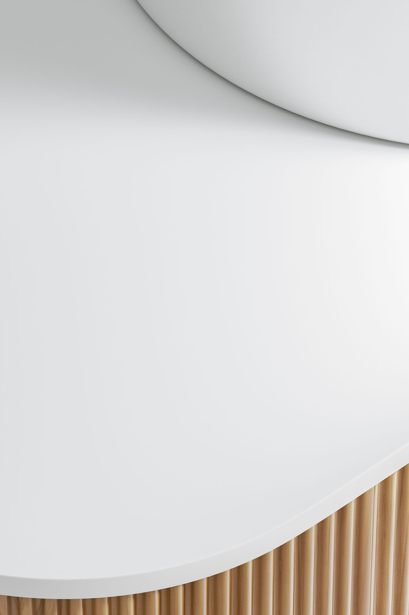 The smooth edge of the white sintered stone top is in focus, with the groove-front timber cabinet just shown. The smooth edge of the white sintered stone top is in focus, with the groove-front timber cabinet just shown.