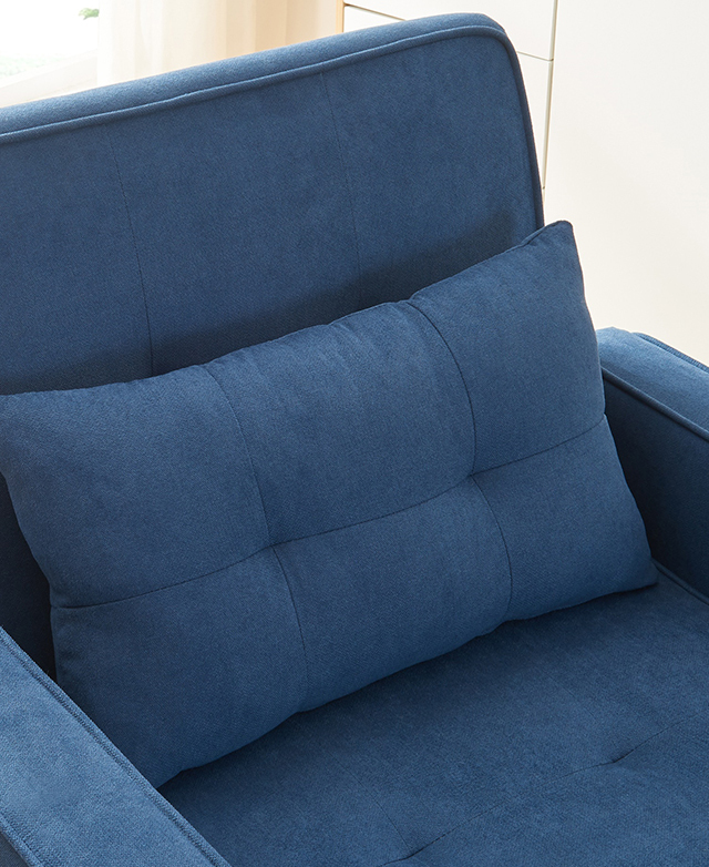A top-down view of the blue single sofa bed details the plump cushion and tufting.