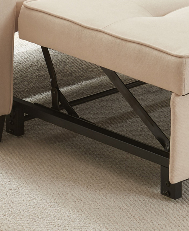 Close side view of the underside of the pull-out section of the sofa bed, which is made of black steel.