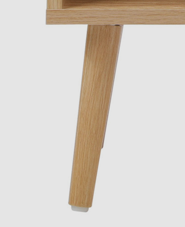 Close up view of a tapered gum wood leg, displaying the natural timber grains and the plastic foot protector.