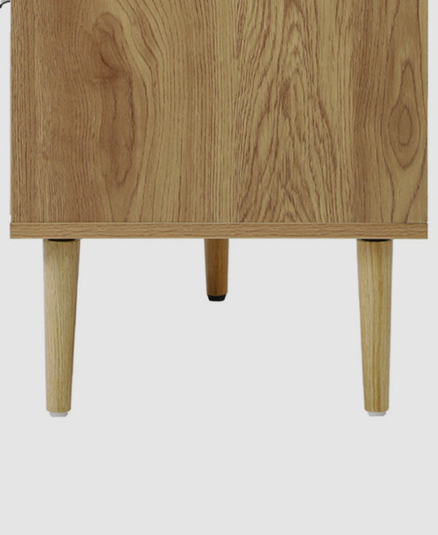 Close up view of the tapered gum wood legs, displaying the natural timber grains and the plastic foot protectors.
