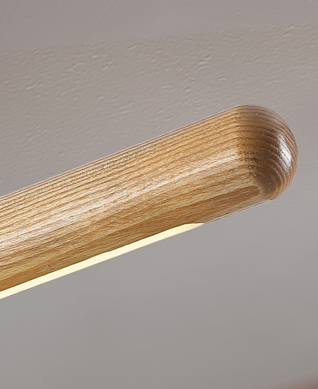 Close up of the ash wood beam light to show the smoothly finished, rounded end and natural grains.