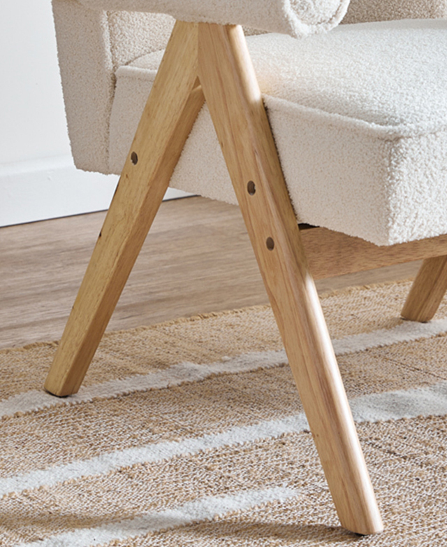 A-shaped rubberwood legs meet a rubberwood support beam beneath the seat of the armchair. A-shaped rubberwood legs meet a rubberwood support beam beneath the seat of the armchair.