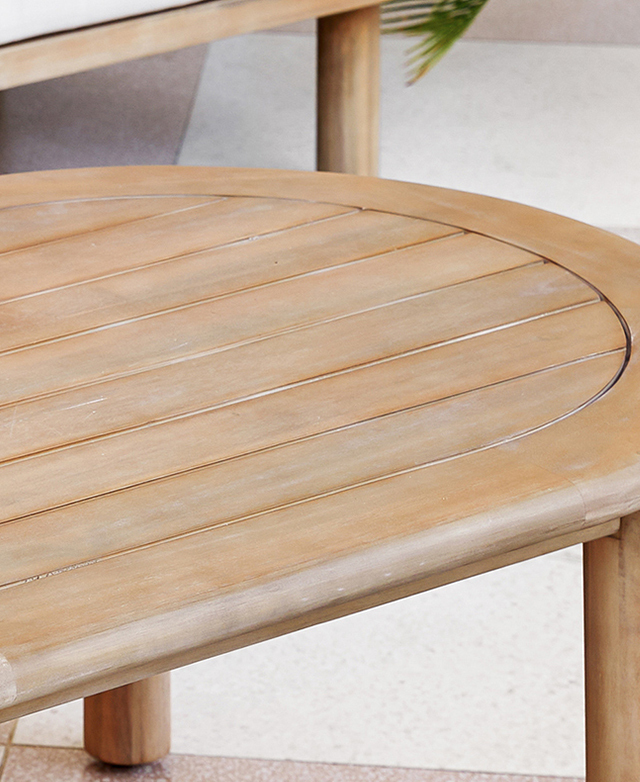 The slatted-top acacia wood coffee table has a gently worn effect. The slatted-top acacia wood coffee table has a gently worn effect.