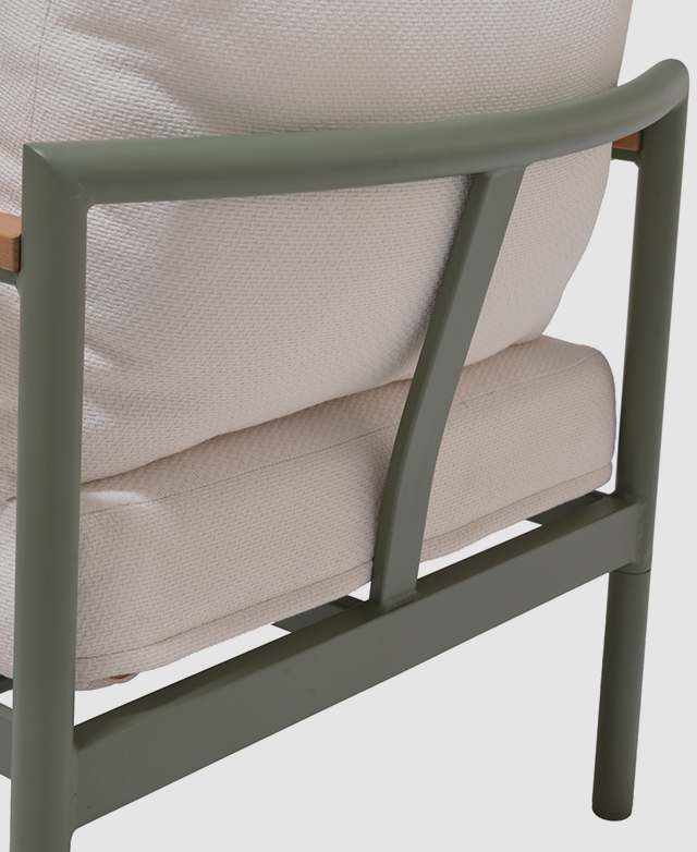 A back view of the sage-coloured aluminium frame is a thick tube form, with cushions placed against it.