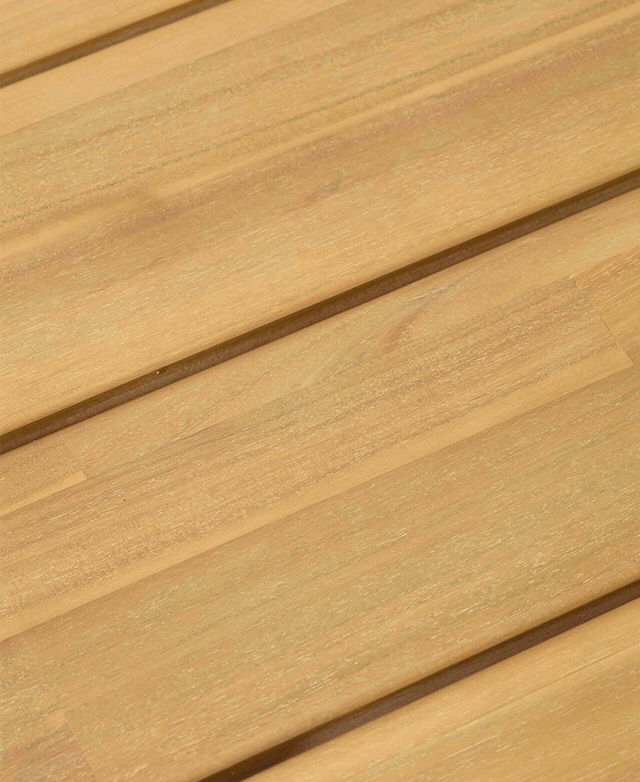 A cropped, bird's eye view of the wooden coffee table emphasises the slatted top and rich, golden hue.