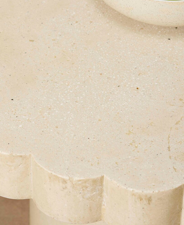 A bird's eye view of the cast stone coffee table highlights the speckles, the soft colour variances, and the scalloped edge. A bird's eye view of the cast stone coffee table highlights the speckles, the soft colour variances, and the scalloped edge.