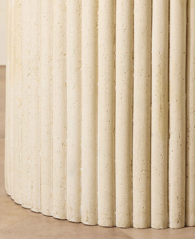 The fluting around the side of the side table spotlight is in focus to stress its texture.