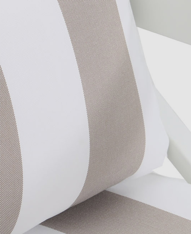Broad taupe and white stripes of the outdoor-suitable Olefin fabric are displayed close up. Broad taupe and white stripes of the outdoor-suitable Olefin fabric are displayed close up.