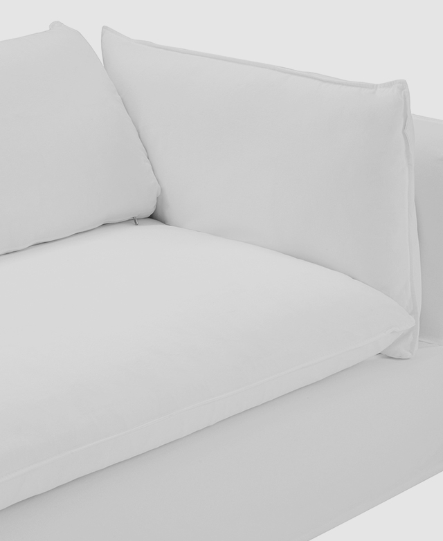 The focus is on one end of the white sofa to demonstrate the wide seats and generously-filled cushions. The focus is on one end of the white sofa to demonstrate the wide seats and generously-filled cushions.