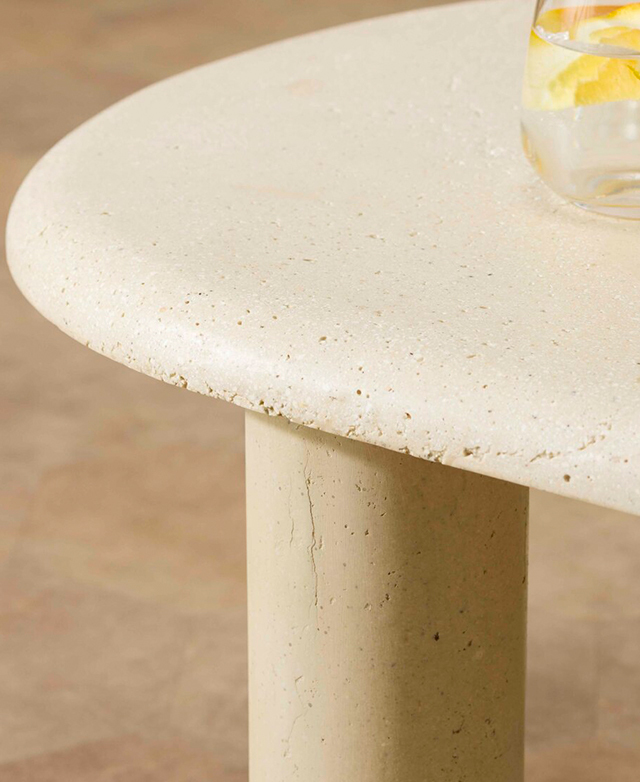 A side view of the stone coffee table presents a half-bullnose edge, which curves gently from the top. A side view of the stone coffee table presents a half-bullnose edge, which curves gently from the top.