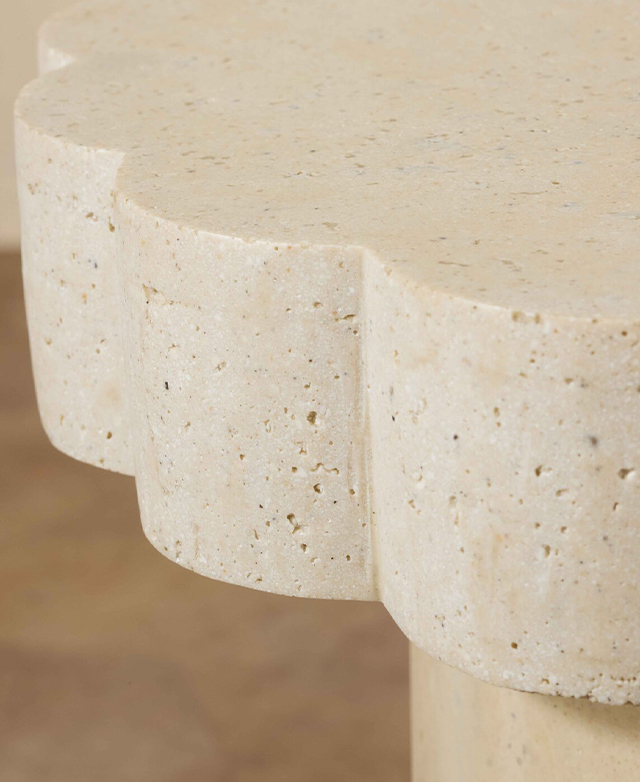 A cropped, side view of the side table calls attention to the deep scalloped top and its subtle colour variances. A cropped, side view of the side table calls attention to the deep scalloped top and its subtle colour variances.