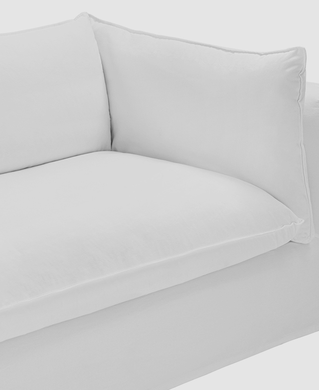 The focus is on one end of the white sofa to demonstrate the wide seats and generously-filled cushions. The focus is on one end of the white sofa to demonstrate the wide seats and generously-filled cushions.