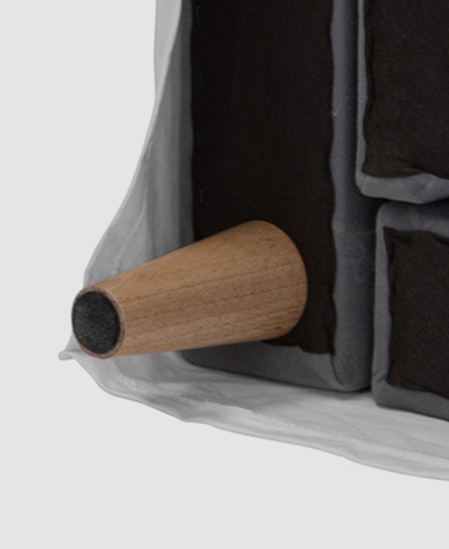 The underside of the sofa and one of the tapered timber legs.