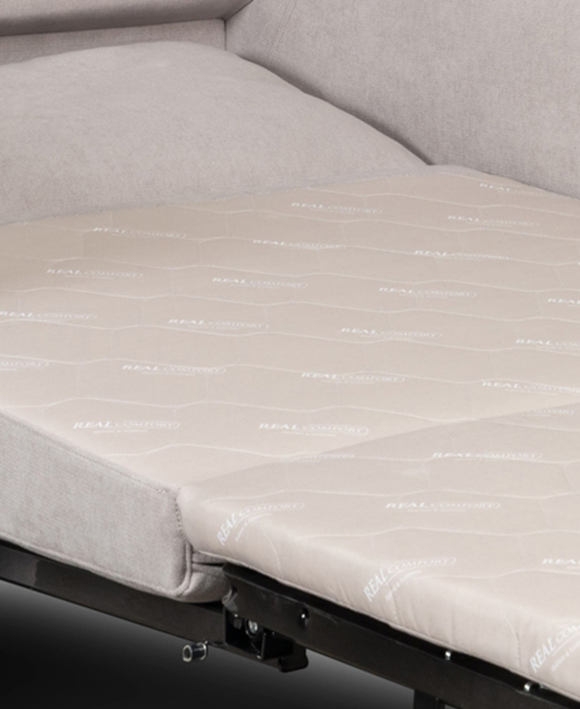 The single armchair sofa bed is unfolded to reveal the inner mattress.