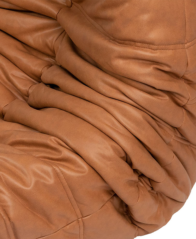 Cropped view zooms in on the tan faux leather's deep pleats. Cropped view zooms in on the tan faux leather's deep pleats.