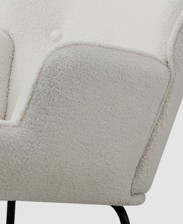 Focus is on the boucle upholstery and its looped pile and thick texture. Focus is on the boucle upholstery and its looped pile and thick texture.