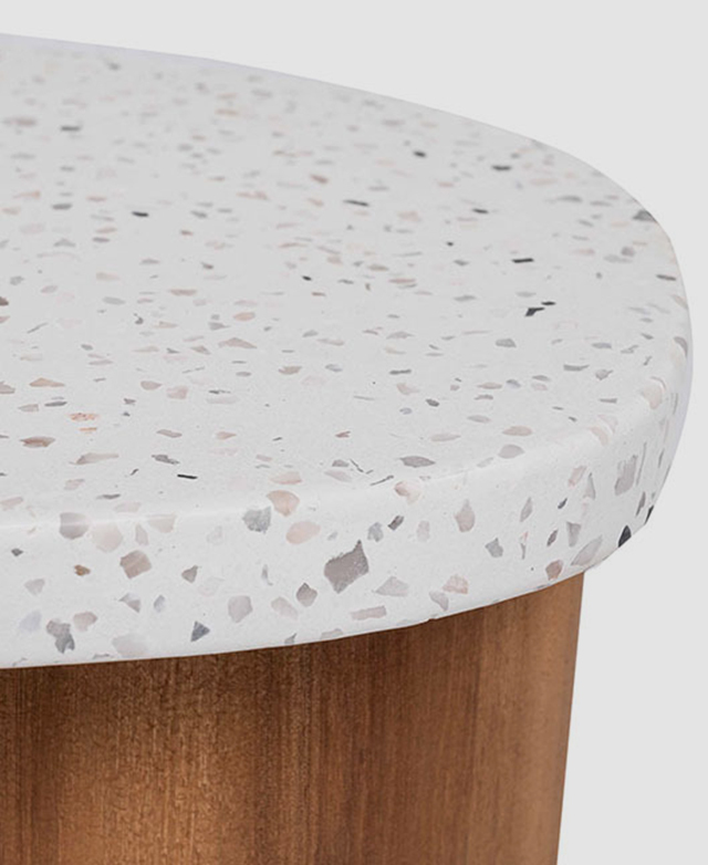 Close up of the terrazzo table top hones in on the soft pink and grey speckled pattern.