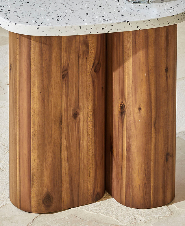 The thick, bissecting acacia wood legs have rich, warm tones and exposed natural grains.
