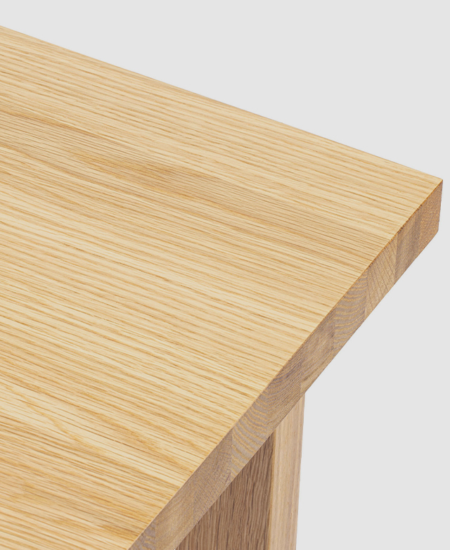 Cropped view of a corner of the desk top underlines the grain effect of the oak wood veneer.
