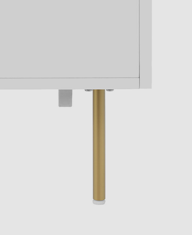 A very slender golden metal leg. A very slender golden metal leg.