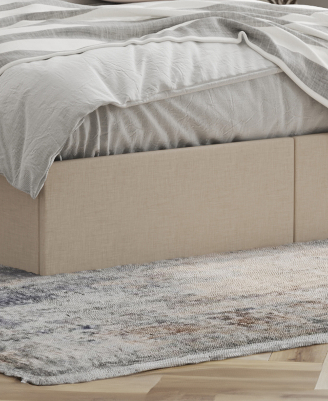 The seam in the centre of the cream, linen-look footend indicates the edges of the two hidden drawers.