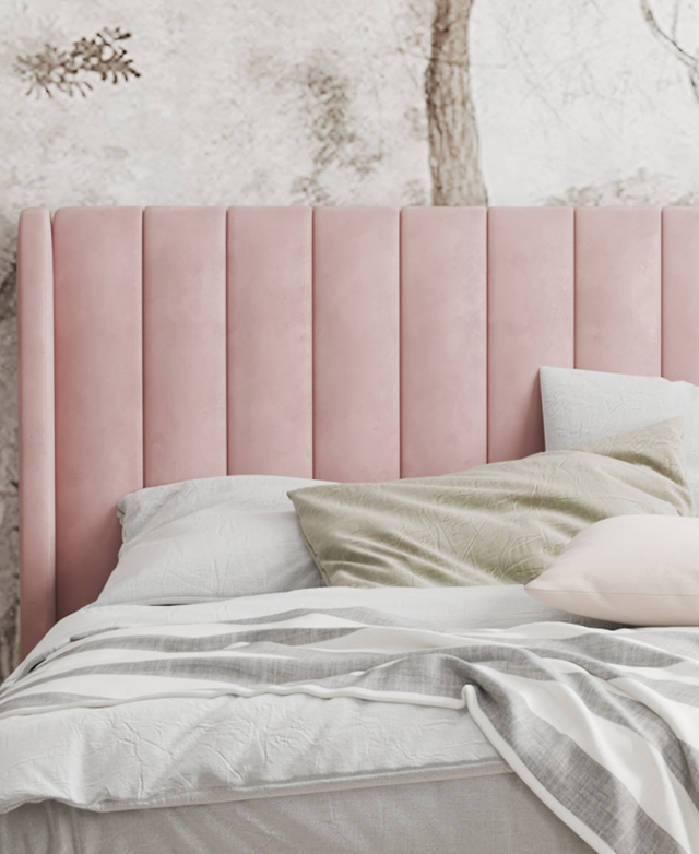 The focus is the bedhead, which is adorned with neat channel tufting. Soft-toned bedding layers dress the bed.