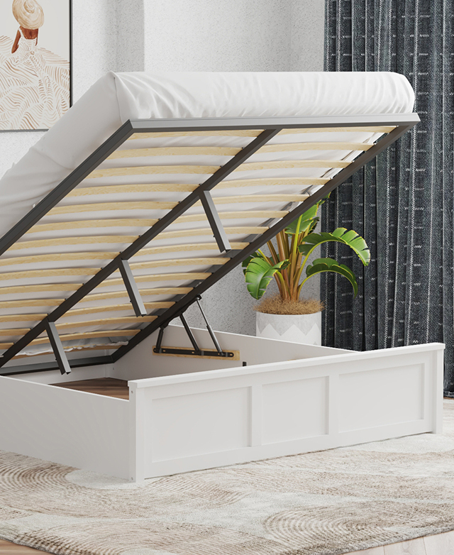 The white panelled bed is shown with a mattress on top, which is elevated on its slats to reveal storage space beneath. The white panelled bed is shown with a mattress on top, which is elevated on its slats to reveal storage space beneath.