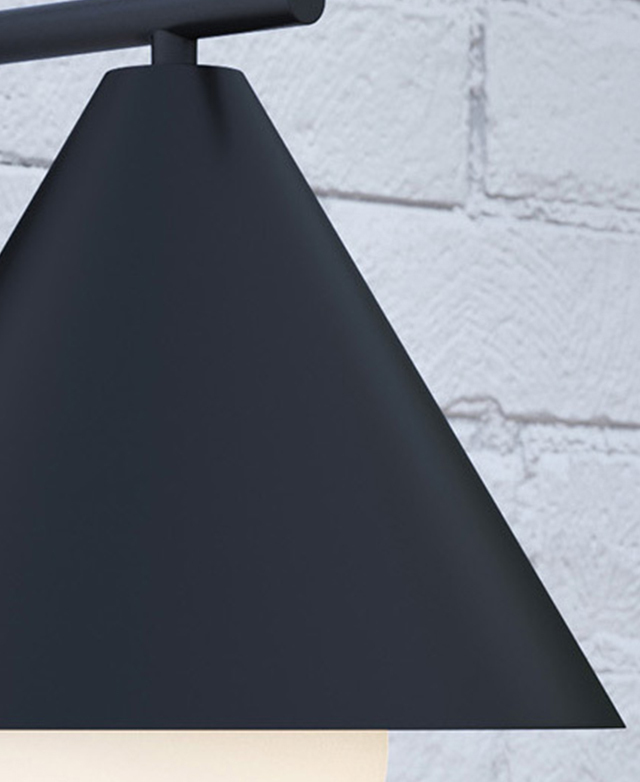 Close-up of the black metal wall light shade, which is smooth metal.