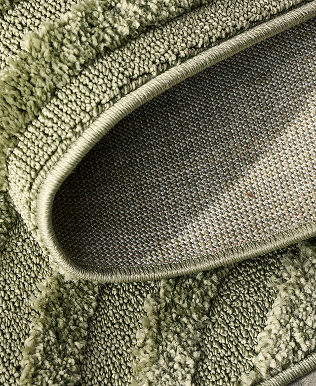 The pistachio rug is folded back on itself.