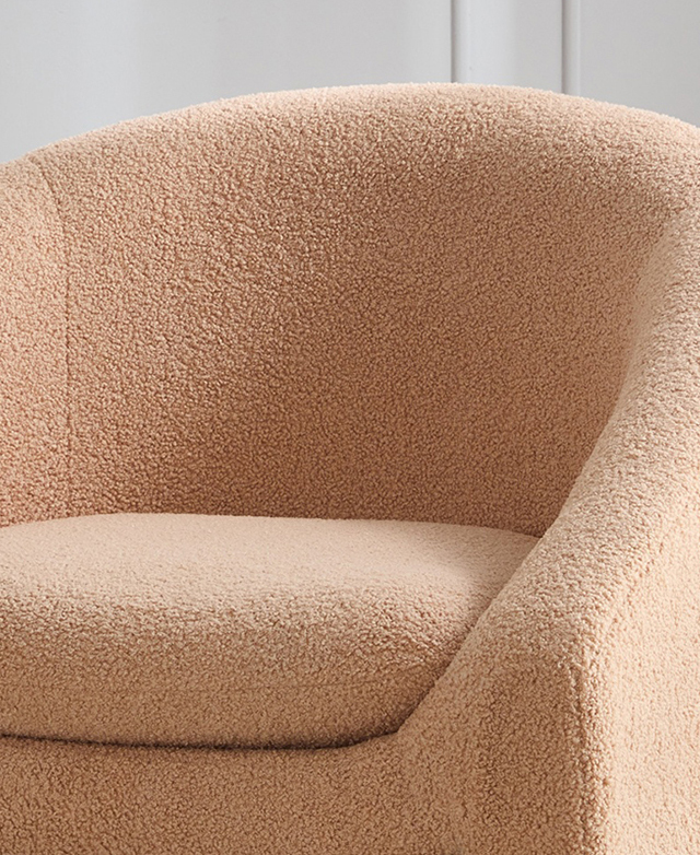 Clay-coloured boucle upholstery covers the frame and the cushion of the tub chair. Clay-coloured boucle upholstery covers the frame and the cushion of the tub chair.