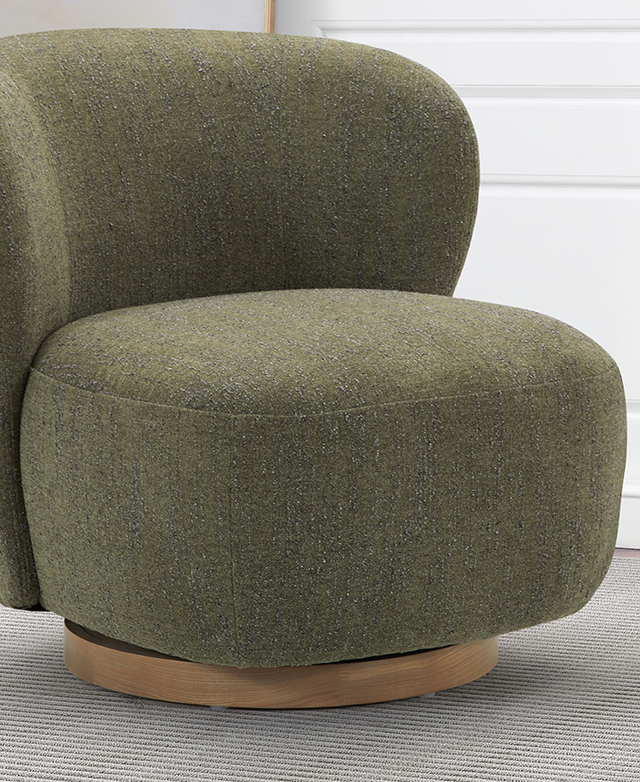 The front of the green swivel accent chair displays the soft edges and curved features.