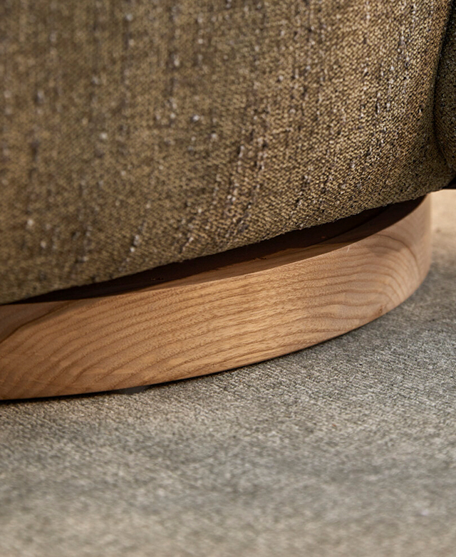 The smoothly-finished ash wood base is flush against a grey carpeted floor.