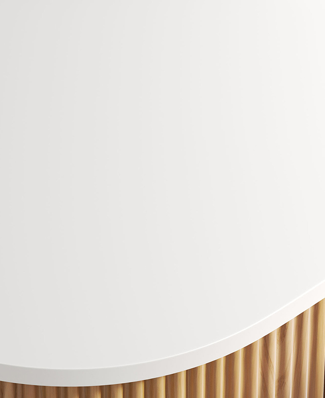 Close-up, top-down angle of the crisp white sintered stone vanity top, which has rounded corners.