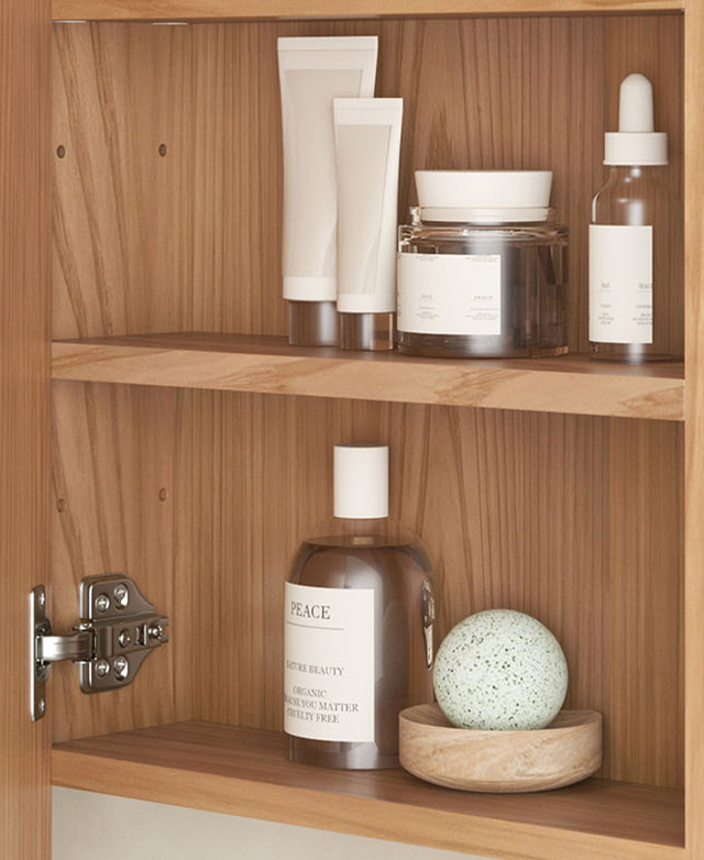 The cabinet door is open to reveal two shelves that are filled with grooming products.