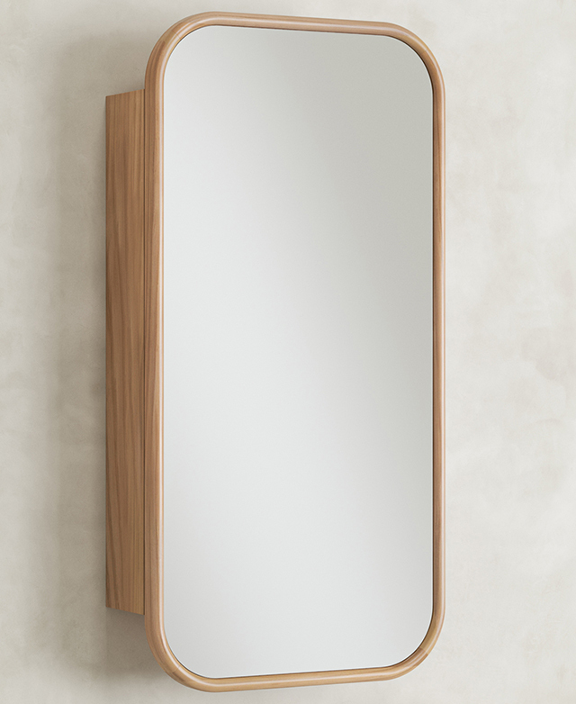 The rectangular, timber-framed, mirrored cabinet is positioned on a concrete-look wall.