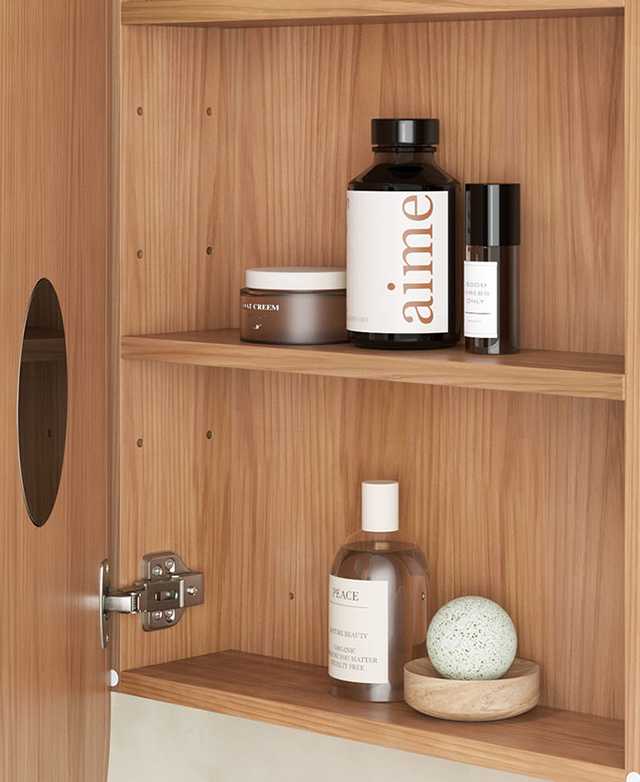 The cabinet door is open to reveal a magnifying mirror and two shelves that are filled with grooming products.