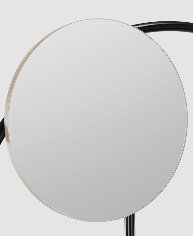 A crisp, round mirror on a black, powder-coated iron frame. A crisp, round mirror on a black, powder-coated iron frame.