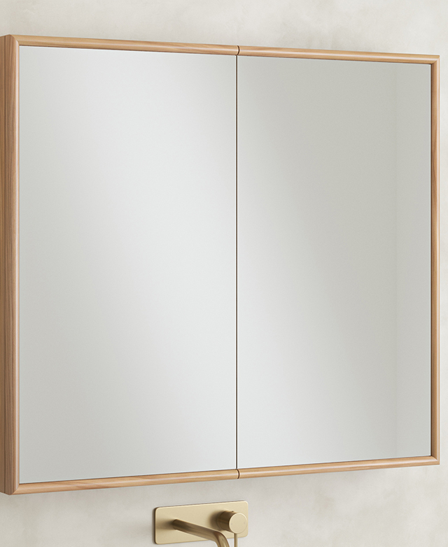 A large, square, mirrored cabinet is positioned on a concrete-look wall. A large, square, mirrored cabinet is positioned on a concrete-look wall.