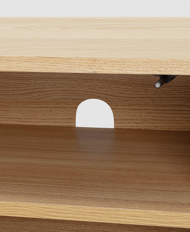 At the back of an internal shelf is a cable hole for electronics cords.