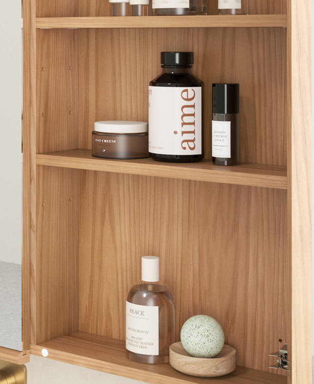 A cabinet door is open to reveal three shelves that are filled with grooming products. A cabinet door is open to reveal three shelves that are filled with grooming products.